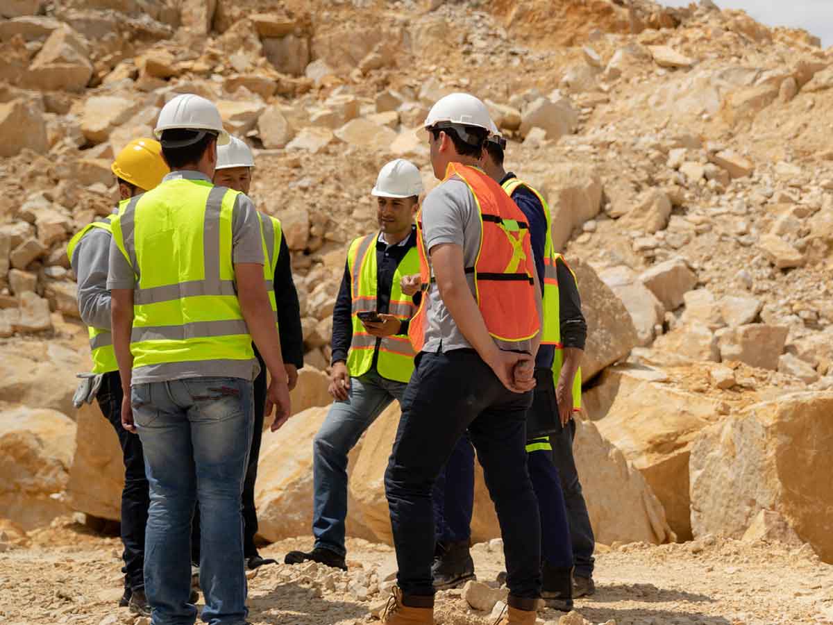 Group of mining workers with one holding a zebra device